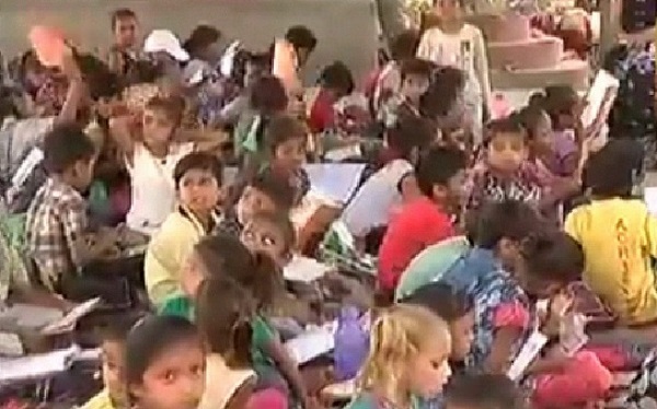 pipalaj students sitting under hot sun